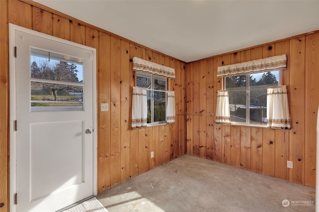 doorway to outside featuring wooden walls