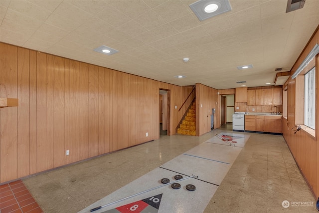 interior space with sink and wooden walls