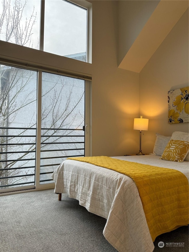 bedroom with a towering ceiling and carpet