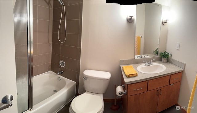 full bathroom with tiled shower / bath, vanity, and toilet