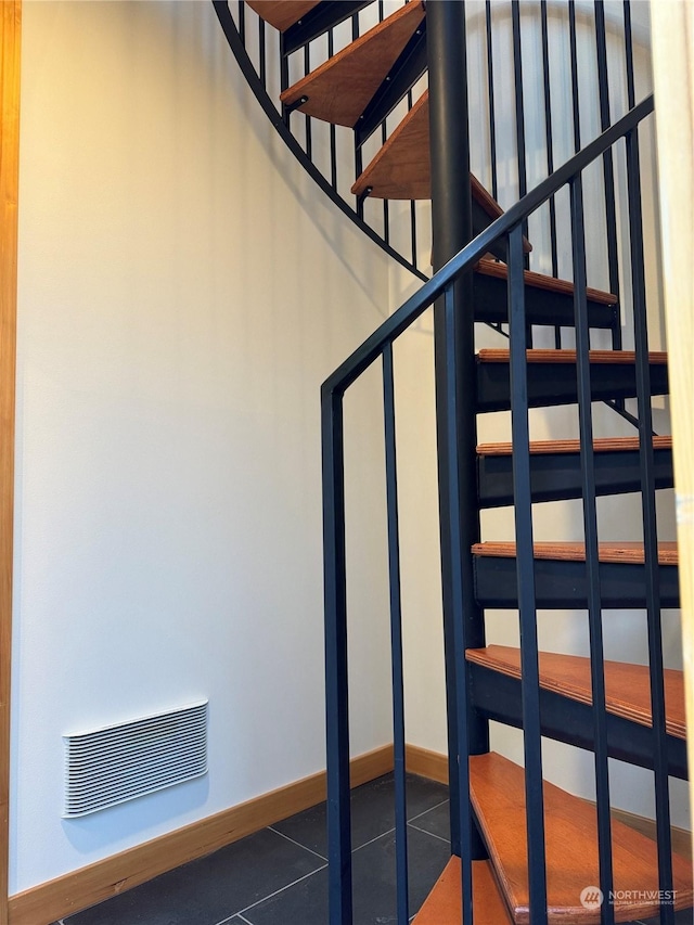 staircase with tile patterned floors