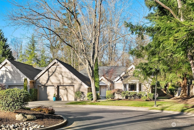 view of front of house with a garage and a front lawn