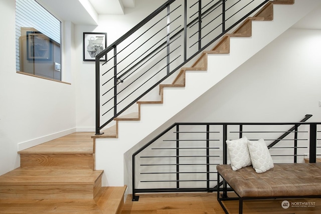 stairway with hardwood / wood-style flooring