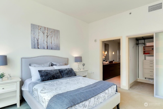 bedroom with light carpet and a closet