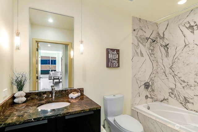 full bathroom with vanity, toilet, and tiled shower / bath