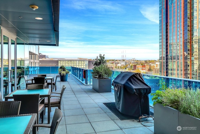 view of patio / terrace featuring area for grilling and a balcony