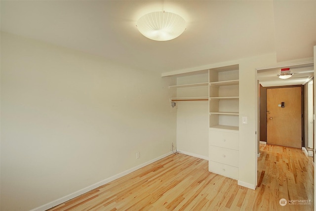 unfurnished bedroom with light hardwood / wood-style floors and a closet