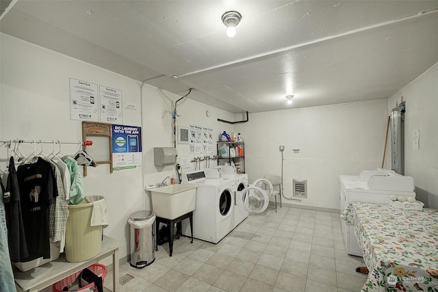 laundry room with light tile patterned floors and washer and dryer