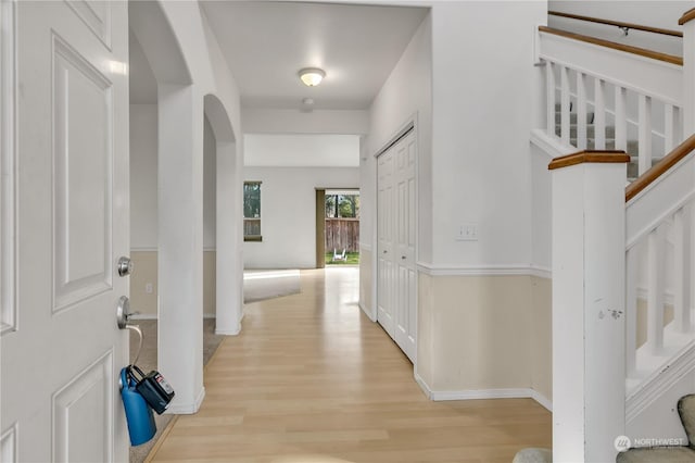 hallway with light hardwood / wood-style floors