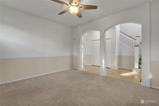 spare room with light carpet and ceiling fan