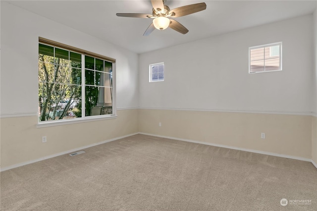 spare room with carpet flooring and ceiling fan