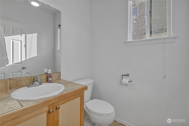 bathroom featuring vanity and toilet