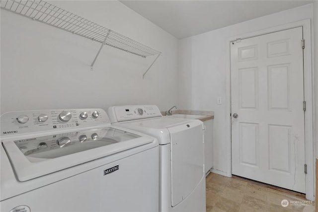 laundry area with cabinets and washing machine and clothes dryer