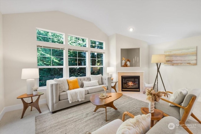 carpeted living room featuring high vaulted ceiling