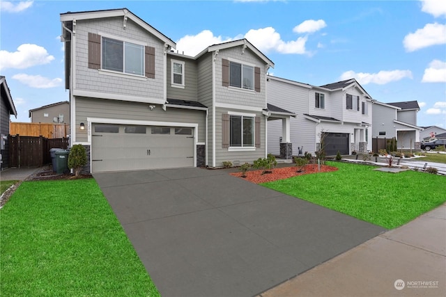 view of front of home featuring a garage and a front lawn