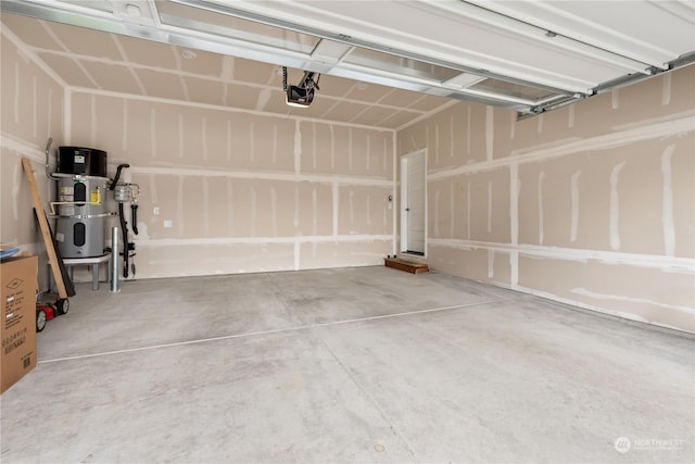 garage featuring a garage door opener and water heater