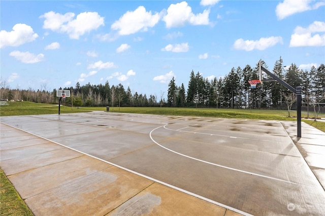 view of sport court featuring a yard