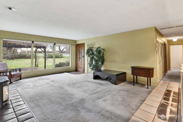 interior space with tile patterned floors and a textured ceiling