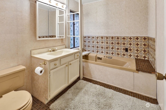 bathroom featuring vanity, tile patterned floors, toilet, and a bathing tub