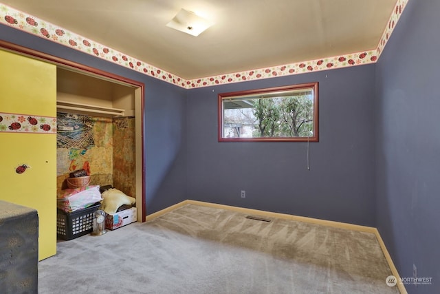 carpeted bedroom with a closet