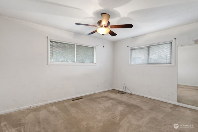 empty room featuring light colored carpet and ceiling fan