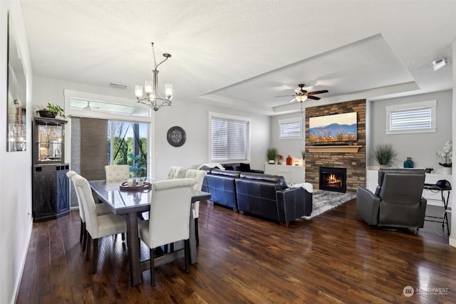 dining room with dark hardwood / wood-style flooring and a tray ceiling