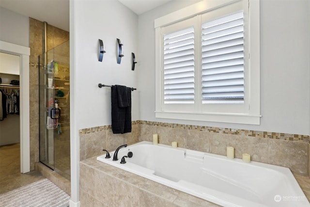 bathroom featuring shower with separate bathtub and tile patterned floors