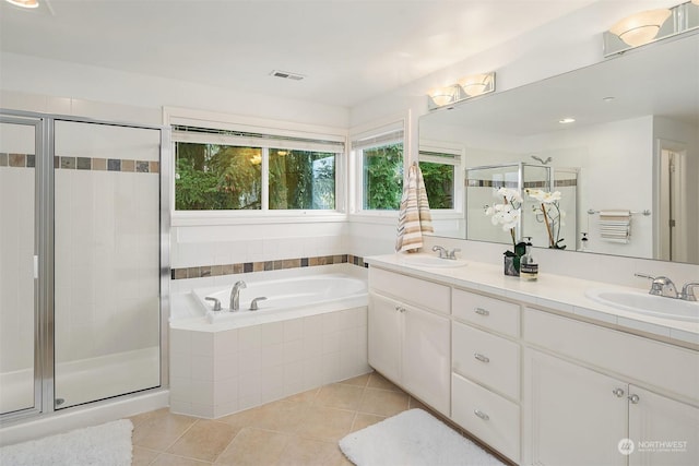 bathroom featuring tile patterned flooring, shower with separate bathtub, and vanity