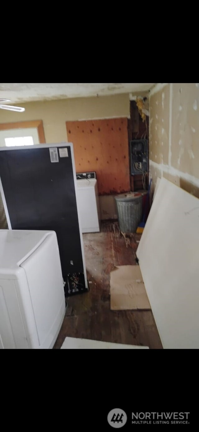 laundry area featuring washer / clothes dryer and wood finished floors