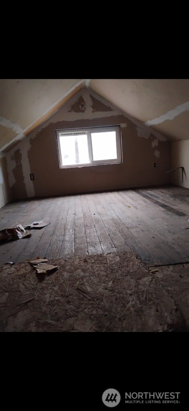 bonus room featuring vaulted ceiling and hardwood / wood-style floors