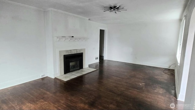 unfurnished living room featuring a ceiling fan, wood finished floors, crown molding, and a fireplace