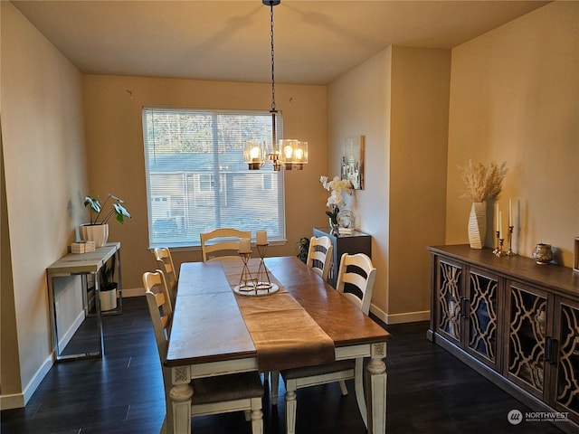 dining area featuring dark wood-type flooring and a notable chandelier