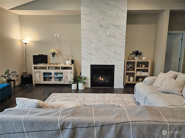 living room with a premium fireplace and dark hardwood / wood-style flooring