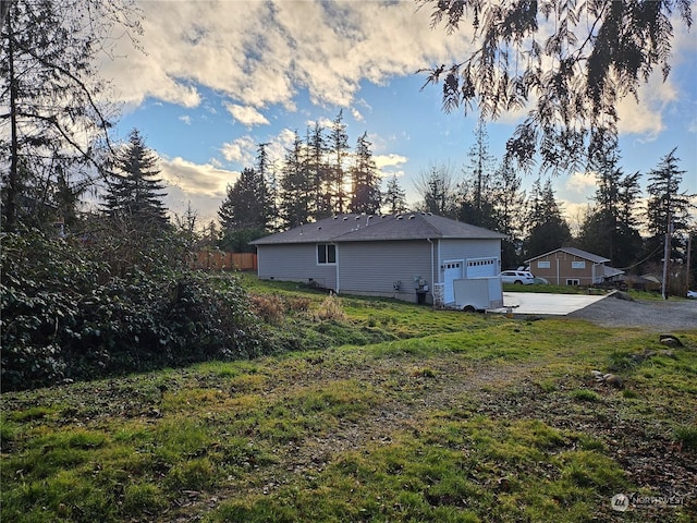 yard at dusk with a garage