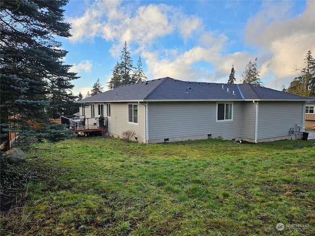 back of property featuring a yard and a deck