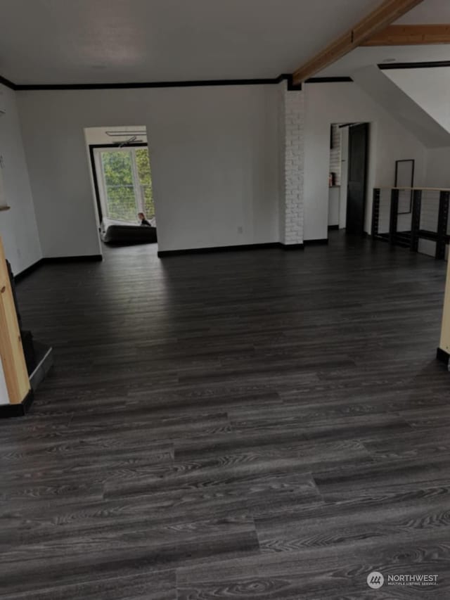 unfurnished living room with ornamental molding, dark hardwood / wood-style floors, and beam ceiling