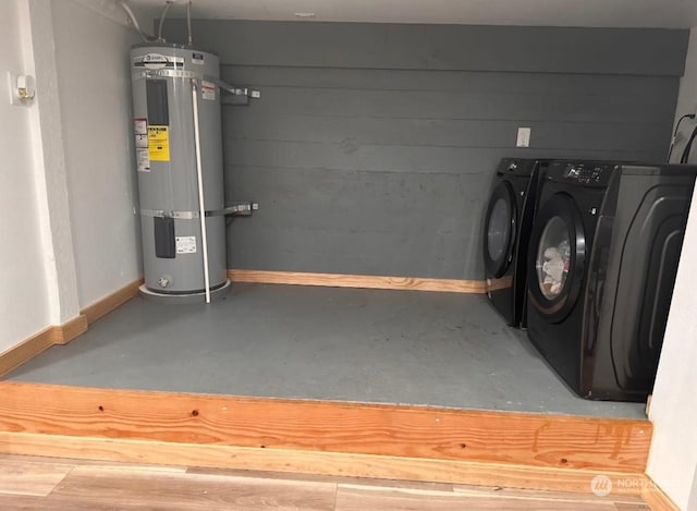 laundry room with separate washer and dryer and water heater