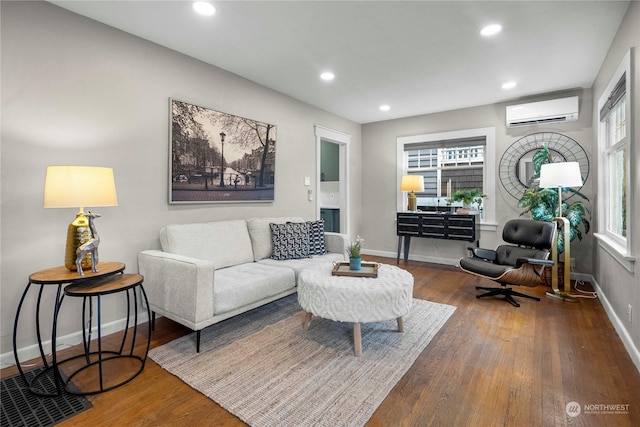 living room with wood-type flooring and a wall mounted AC