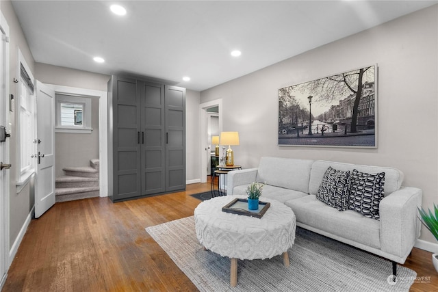 living room featuring recessed lighting, stairway, baseboards, and wood finished floors