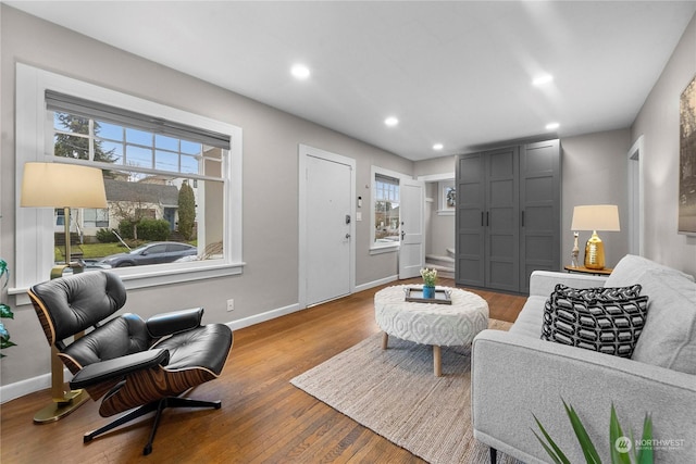 living room featuring recessed lighting, baseboards, and wood finished floors