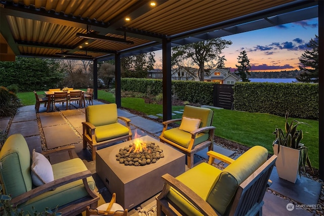 patio terrace at dusk with a yard and a fire pit