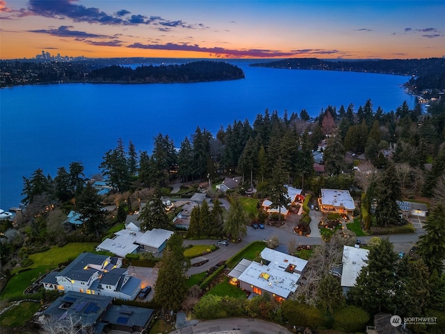 aerial view at dusk with a water view