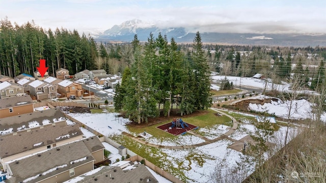 snowy aerial view featuring a mountain view