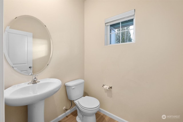 bathroom with wood-type flooring and toilet