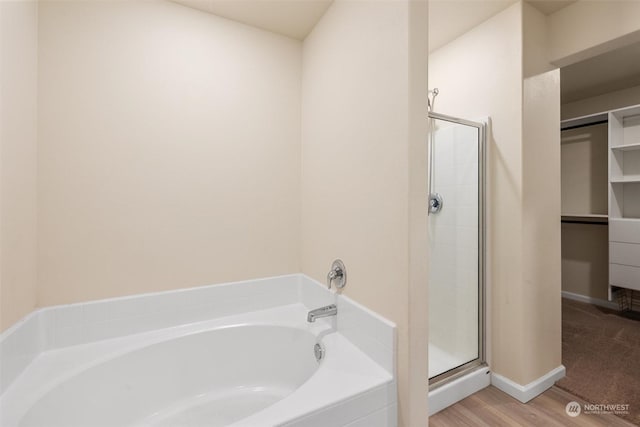 bathroom with separate shower and tub and hardwood / wood-style floors