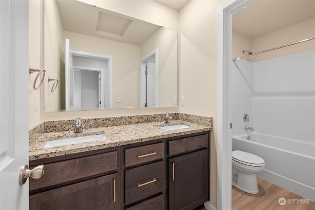 full bathroom with vanity, wood-type flooring, bathing tub / shower combination, and toilet