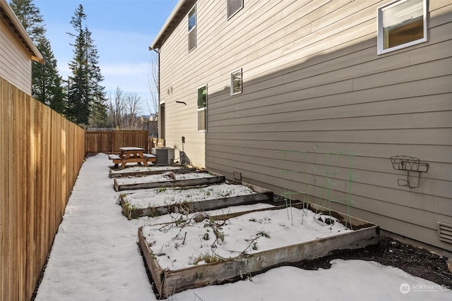 view of snow covered exterior featuring cooling unit