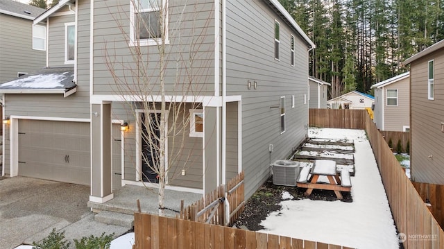 exterior space featuring a garage and central air condition unit