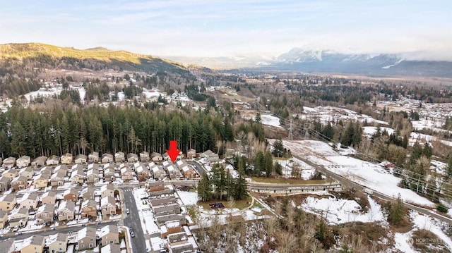 snowy aerial view with a mountain view