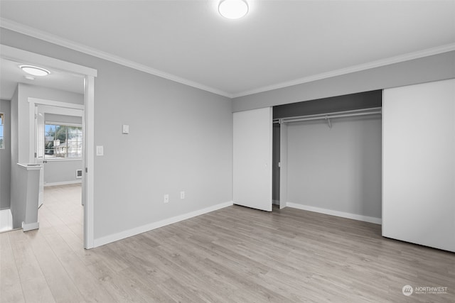 unfurnished bedroom with a closet, ornamental molding, and light hardwood / wood-style flooring